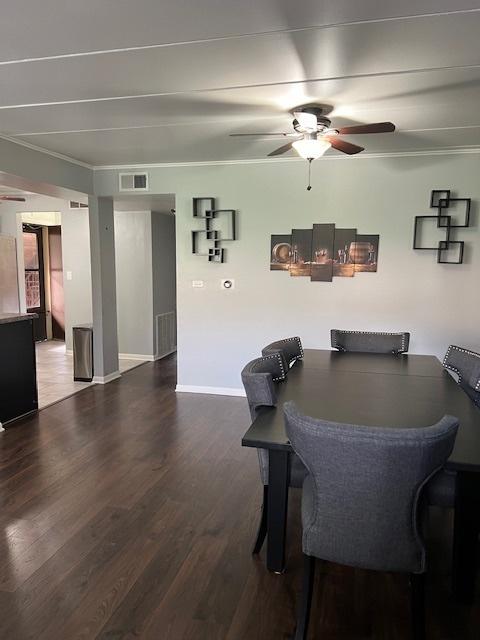 dining room featuring hardwood / wood-style flooring, ornamental molding, and ceiling fan