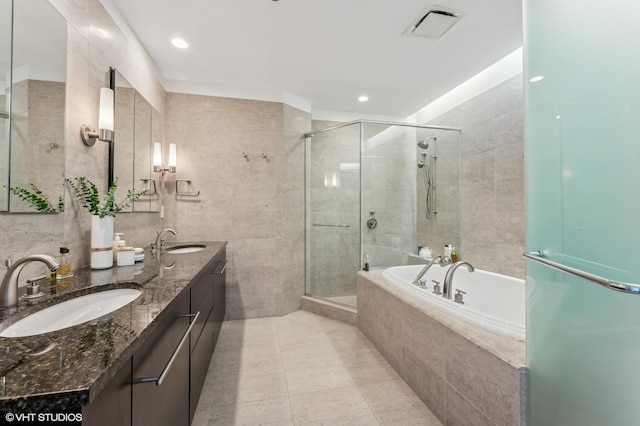 bathroom featuring tile walls, vanity, tile patterned floors, and separate shower and tub