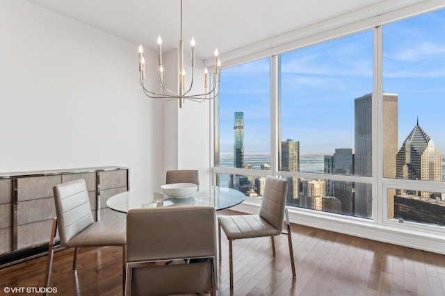 dining area featuring a water view, floor to ceiling windows, dark hardwood / wood-style flooring, and a notable chandelier