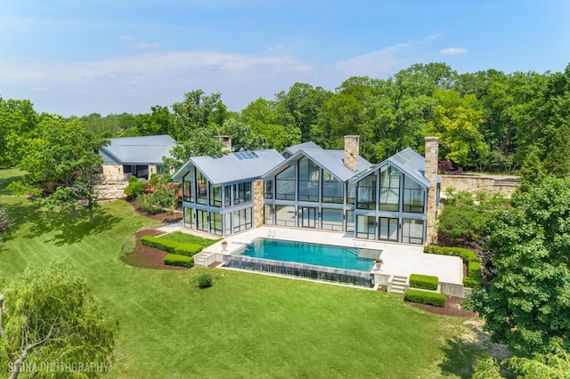 28 Brinker Rd, Barrington Hills, IL 60010 - rear view of property featuring a patio area, an outdoor pool, a yard, a chimney, and glass enclosure