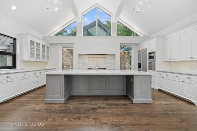 28 Brinker Rd, Barrington Hills, IL 60010 - kitchen featuring white cabinets, beam ceiling, glass insert cabinets, plenty of natural light, and dark wood-style flooring
