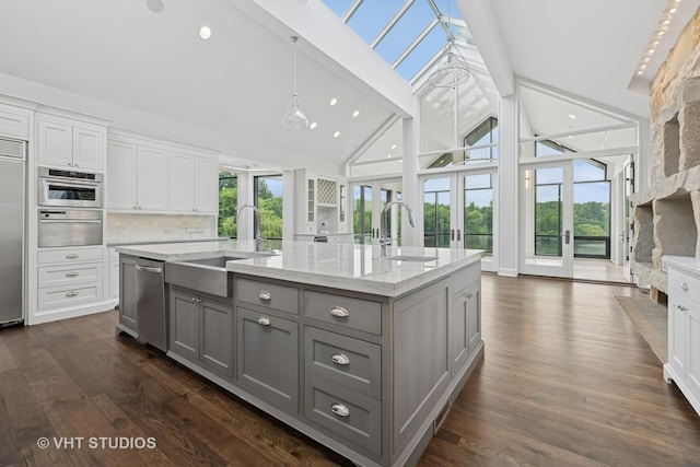 28 Brinker Rd, Barrington Hills, IL 60010 - kitchen featuring gray cabinetry, a warming drawer, healthy amount of natural light, an island with sink, and high vaulted ceiling