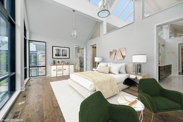 28 Brinker Rd, Barrington Hills, IL 60010 - bedroom with high vaulted ceiling, wood finished floors, beamed ceiling, and ensuite bathroom