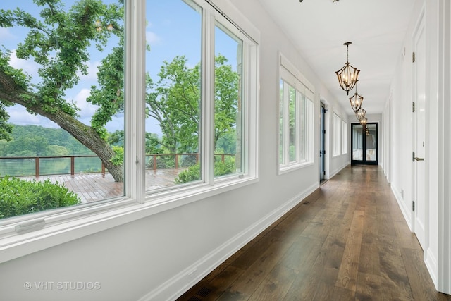 28 Brinker Rd, Barrington Hills, IL 60010 - hall featuring a chandelier and dark wood-style floors