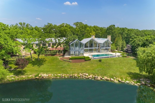 28 Brinker Rd, Barrington Hills, IL 60010 - rear view of property featuring an outdoor pool, a lawn, glass enclosure, and a water view