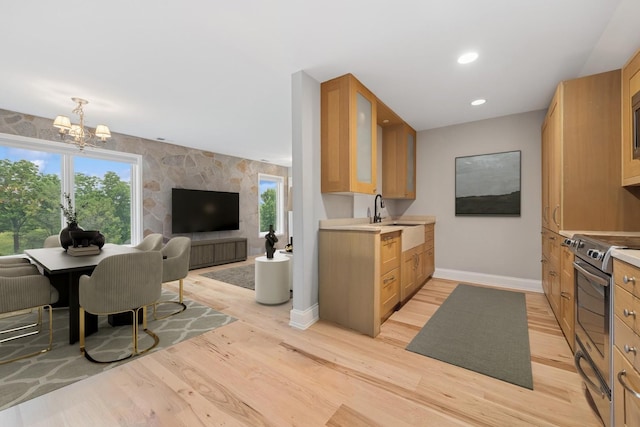 28 Brinker Rd, Barrington Hills, IL 60010 - kitchen with stainless steel electric stove, open floor plan, a chandelier, light wood-type flooring, and light countertops