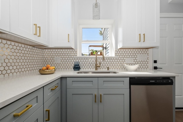 kitchen with sink, gray cabinetry, stainless steel dishwasher, decorative backsplash, and white cabinets