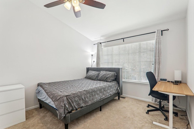 carpeted bedroom with vaulted ceiling and ceiling fan