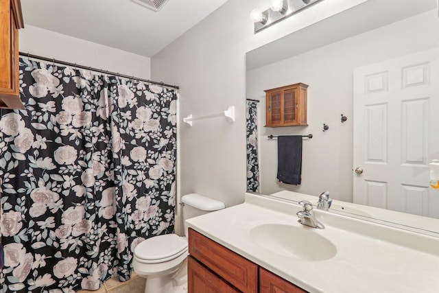 bathroom featuring vanity, toilet, and tile patterned flooring