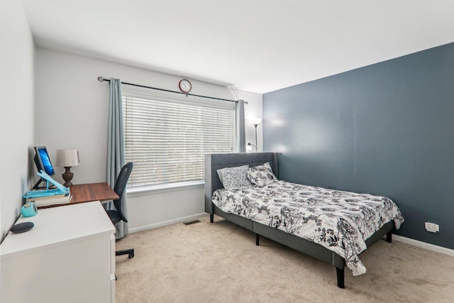 bedroom featuring light carpet