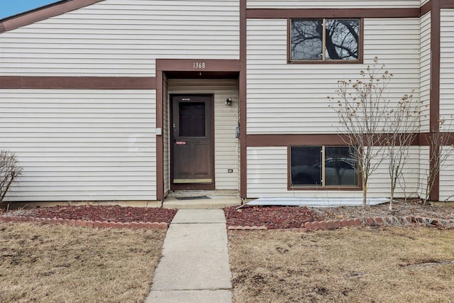 doorway to property featuring a yard