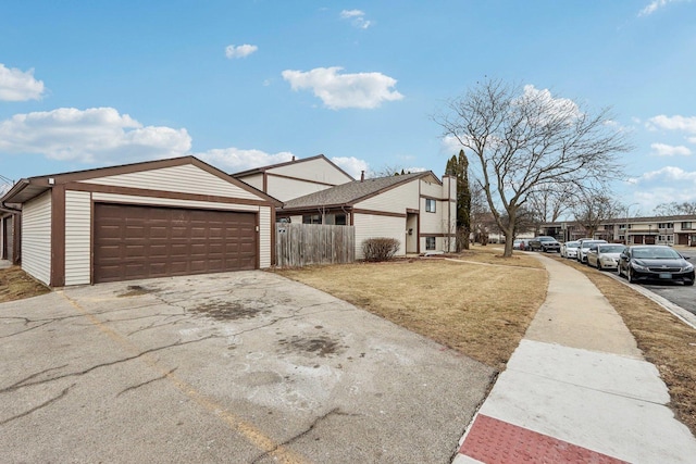 view of side of property featuring a garage and a yard