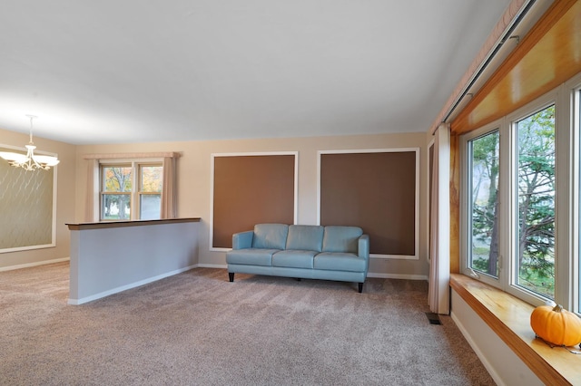 sitting room featuring light carpet and a notable chandelier