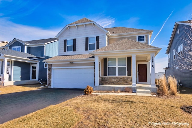 view of front property featuring a garage and a front yard