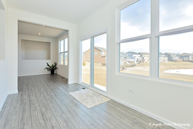 unfurnished room with light hardwood / wood-style flooring