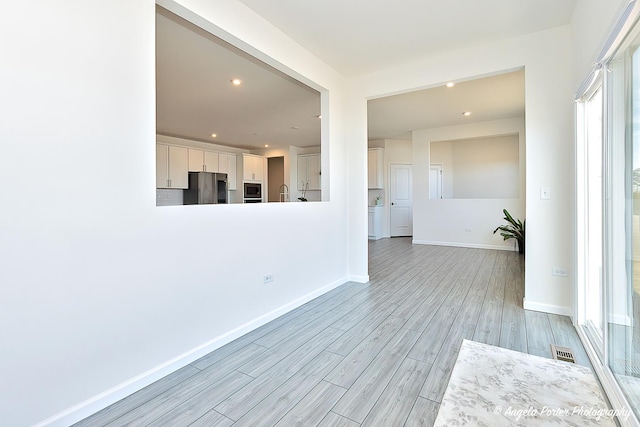 unfurnished living room with light hardwood / wood-style floors