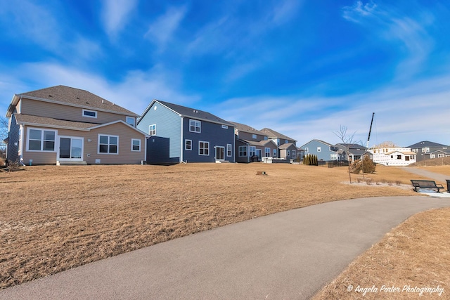 back of property with a lawn