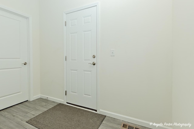 doorway with light wood-type flooring