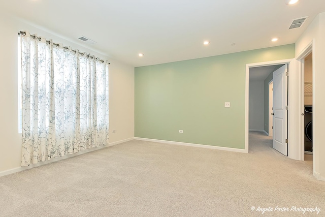 empty room featuring light carpet