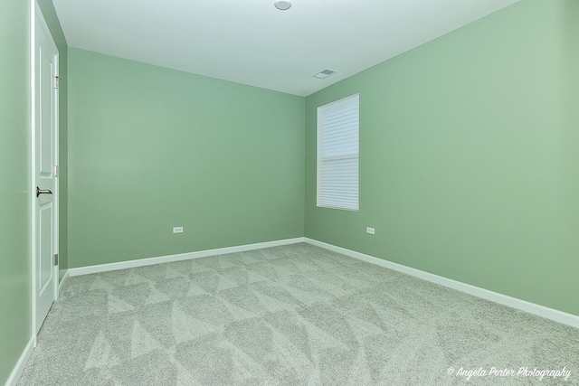 unfurnished room featuring light colored carpet