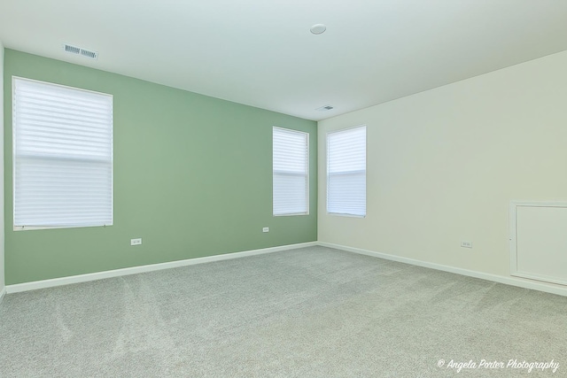 spare room with light colored carpet