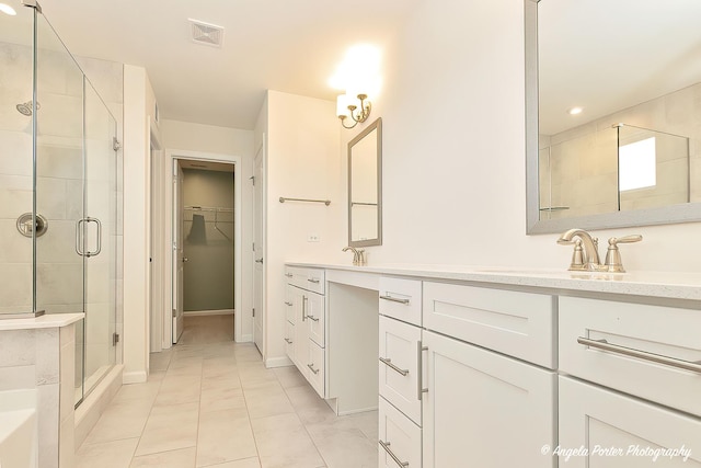 bathroom featuring vanity and an enclosed shower