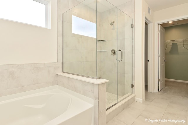 bathroom with tile patterned flooring and independent shower and bath