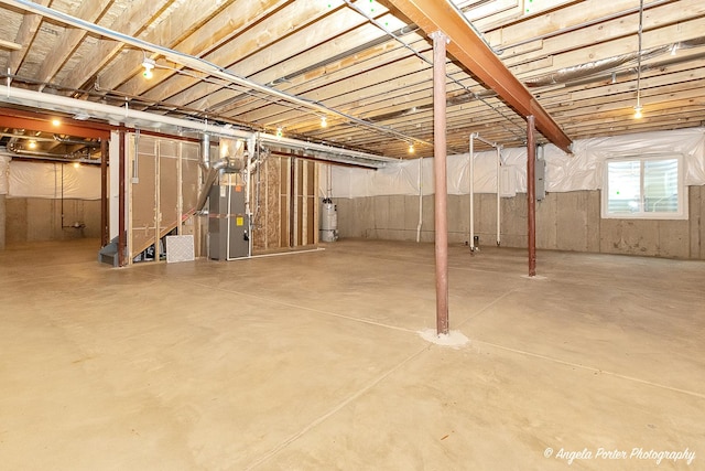 basement with electric water heater, heating unit, and electric panel