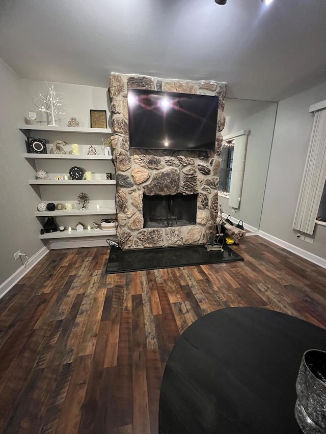 living room featuring a fireplace and wood-type flooring