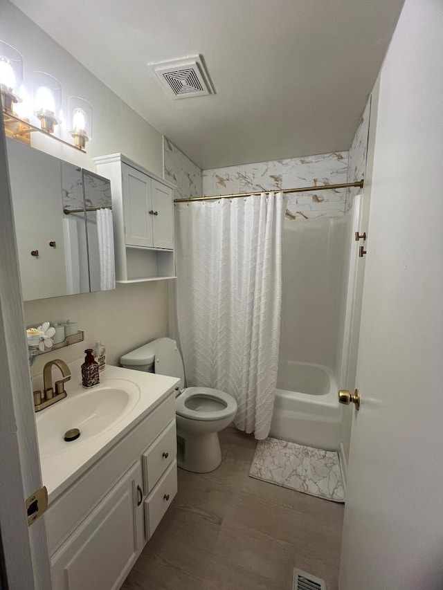 full bathroom with vanity, shower / tub combo with curtain, and toilet