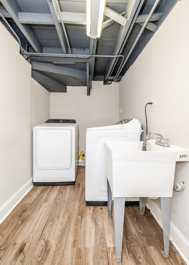 laundry room featuring light hardwood / wood-style floors and washer and dryer