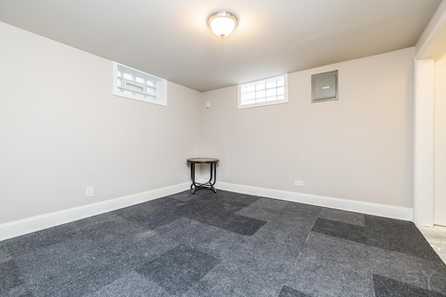 basement featuring electric panel and dark colored carpet