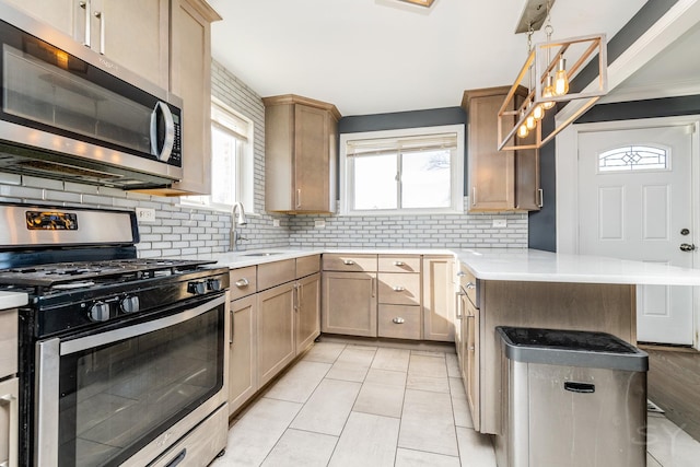 kitchen featuring light brown cabinetry, sink, and stainless steel appliances