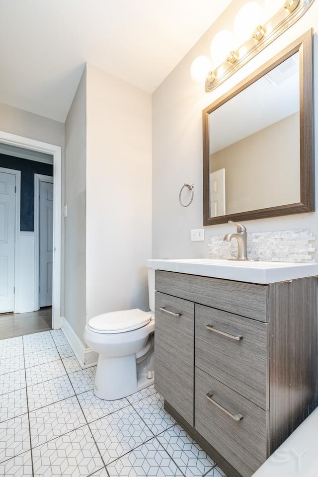 bathroom with vanity, toilet, and tile patterned flooring