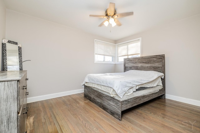 bedroom with ceiling fan and wood-type flooring