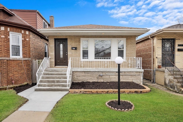 view of exterior entry featuring a lawn