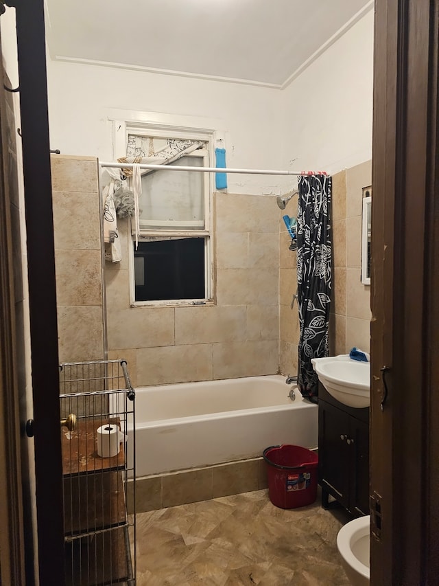 full bathroom with shower / bath combo, tile walls, vanity, and toilet