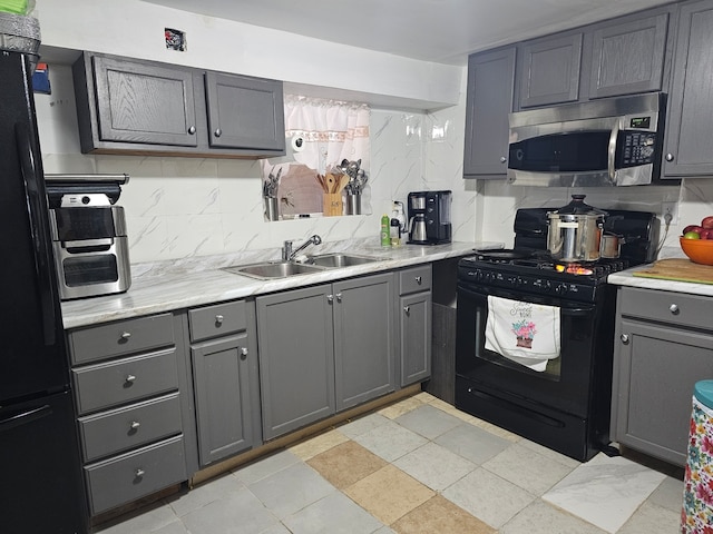 kitchen featuring gray cabinets, sink, and black appliances