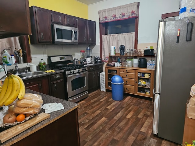 kitchen featuring dark brown cabinetry, sink, dark hardwood / wood-style flooring, stainless steel appliances, and decorative backsplash