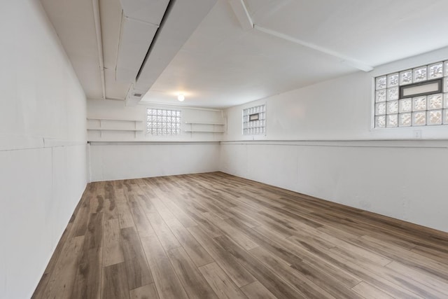 basement with hardwood / wood-style flooring