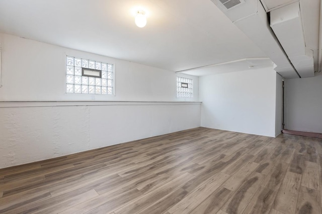 basement featuring wood-type flooring and plenty of natural light