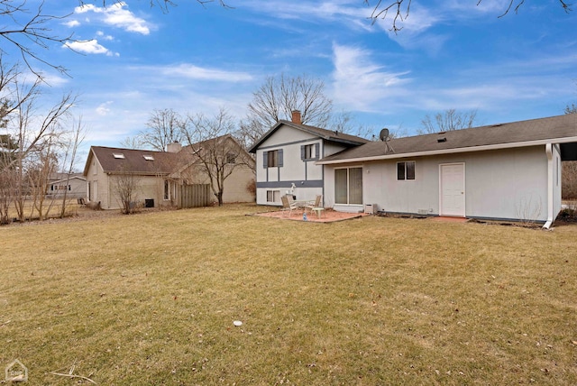 rear view of house with a yard and a patio area