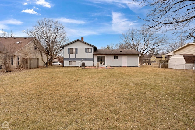 back of property featuring cooling unit and a lawn