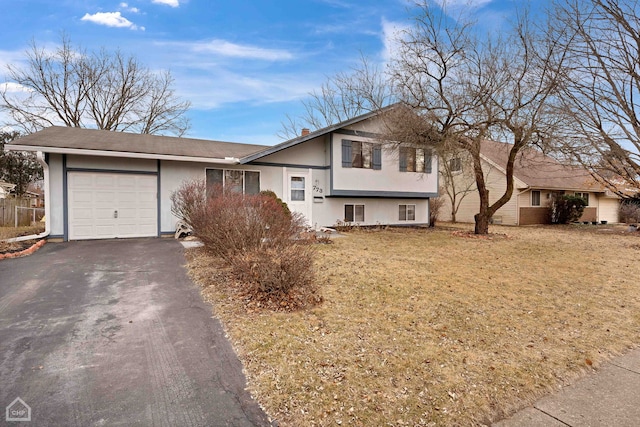 split level home featuring a garage and a front yard