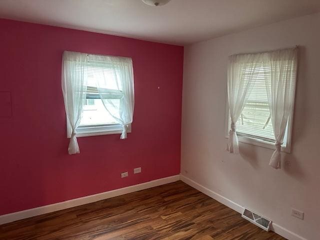 spare room featuring dark hardwood / wood-style floors