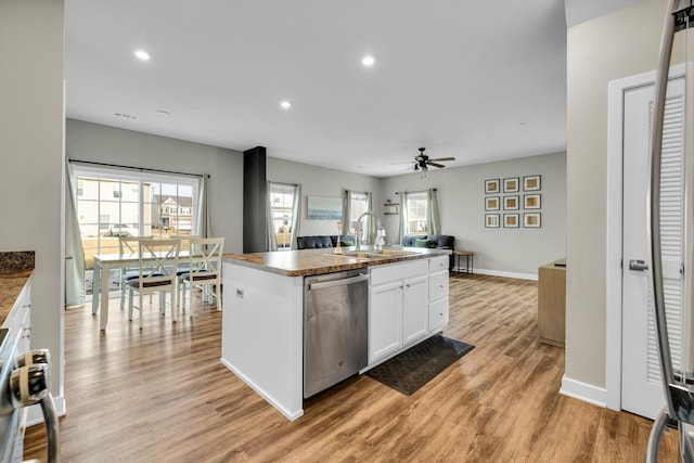 kitchen featuring sink, white cabinetry, a center island with sink, light hardwood / wood-style flooring, and dishwasher