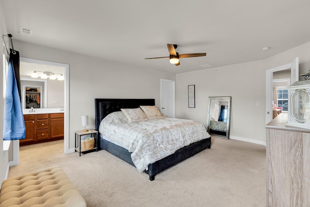 bedroom with light carpet, ceiling fan, and ensuite bathroom