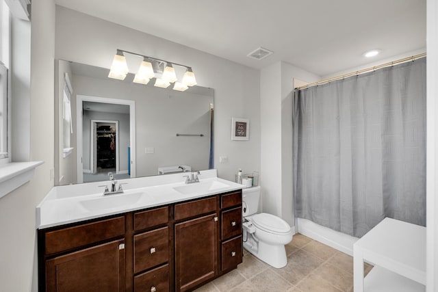 bathroom with tile patterned flooring, vanity, and toilet