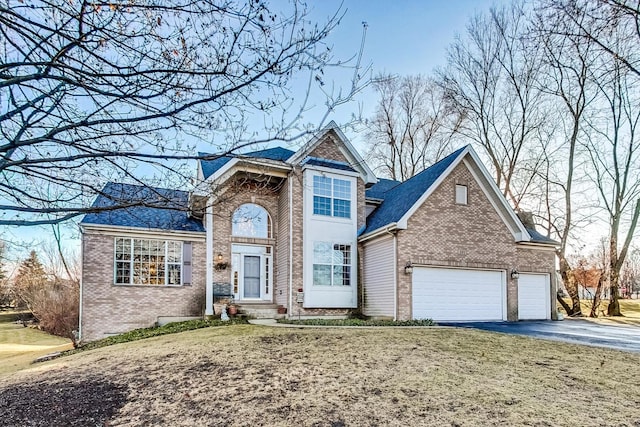 view of property with a garage and a front lawn