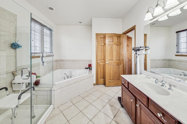 bathroom with vanity, tile patterned floors, and shower with separate bathtub